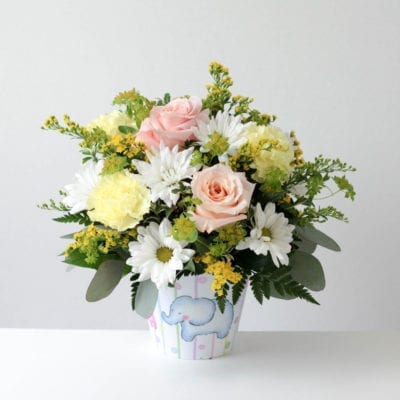 Baby Pail Flowers - Roses, daisy poms, and carnations are accented by seasonal greens and fillers