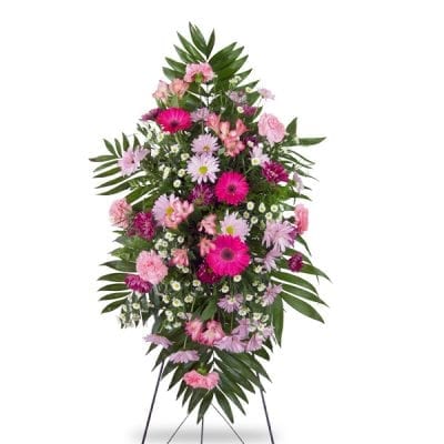 Sympathy standing spray in pinks and purples.